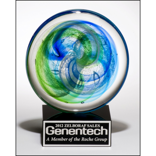 Art glass disk with blue and light green accents on black glass base with felt bottom