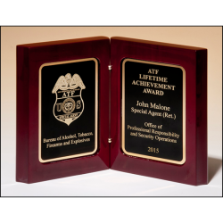 High gloss rosewood stained book award. Two gold plates with black centers