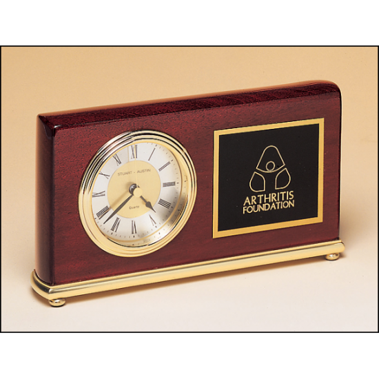Rosewood stained piano finish Airflyte clock on a brass base.