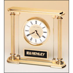Airflyte clock with glass upright, brass feet and top and metal goldtone columns