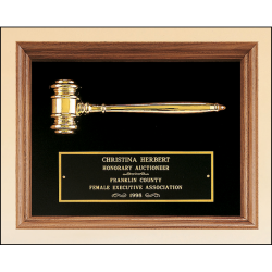 American walnut frame with a gold electroplated metal gavel on choice of velour backgrounds.